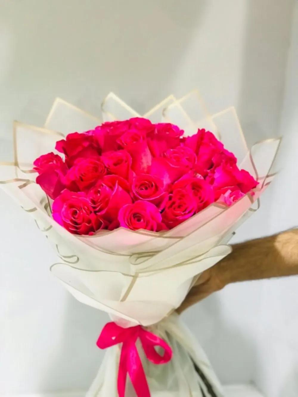 Fuchsia roses bouquet wrapped in white paper Nundefined