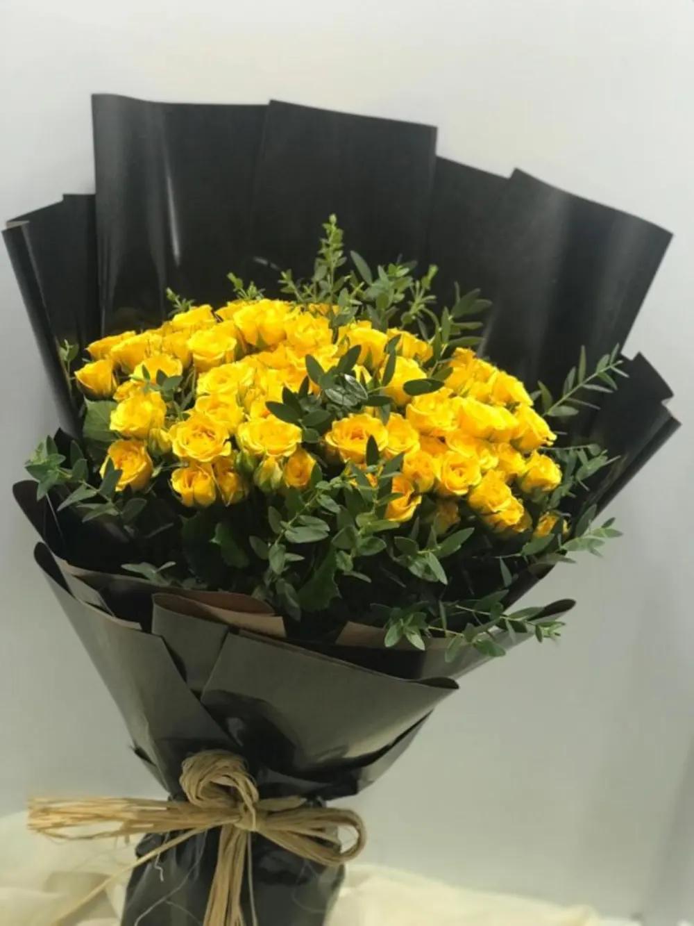 Yellow roses bouquet with eucalyptus wrapped in black paper Nundefined
