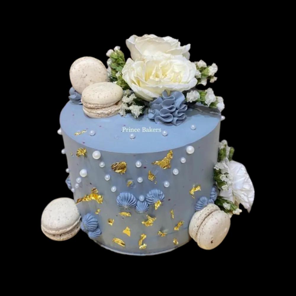 Belgian Chocolate Cake topped with fresh flowers and macrons