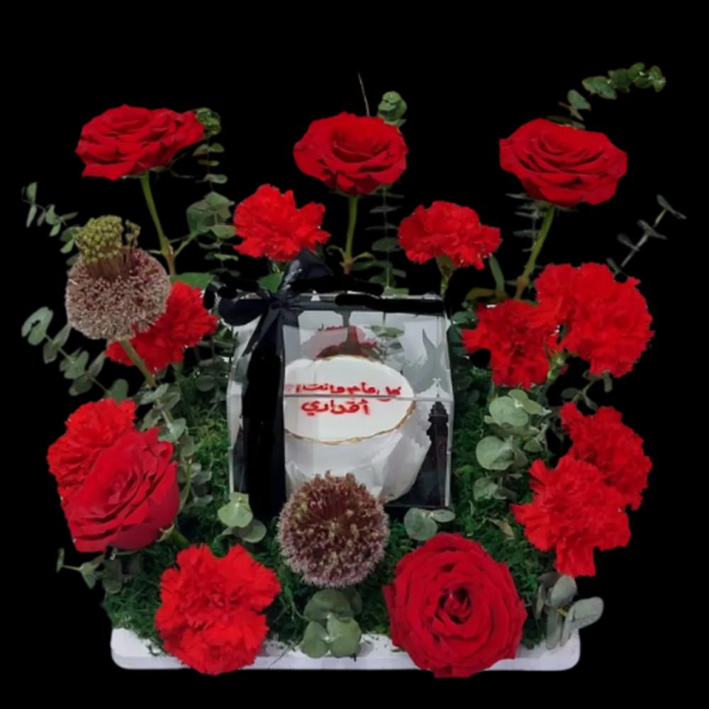 A tray of red roses with cakes