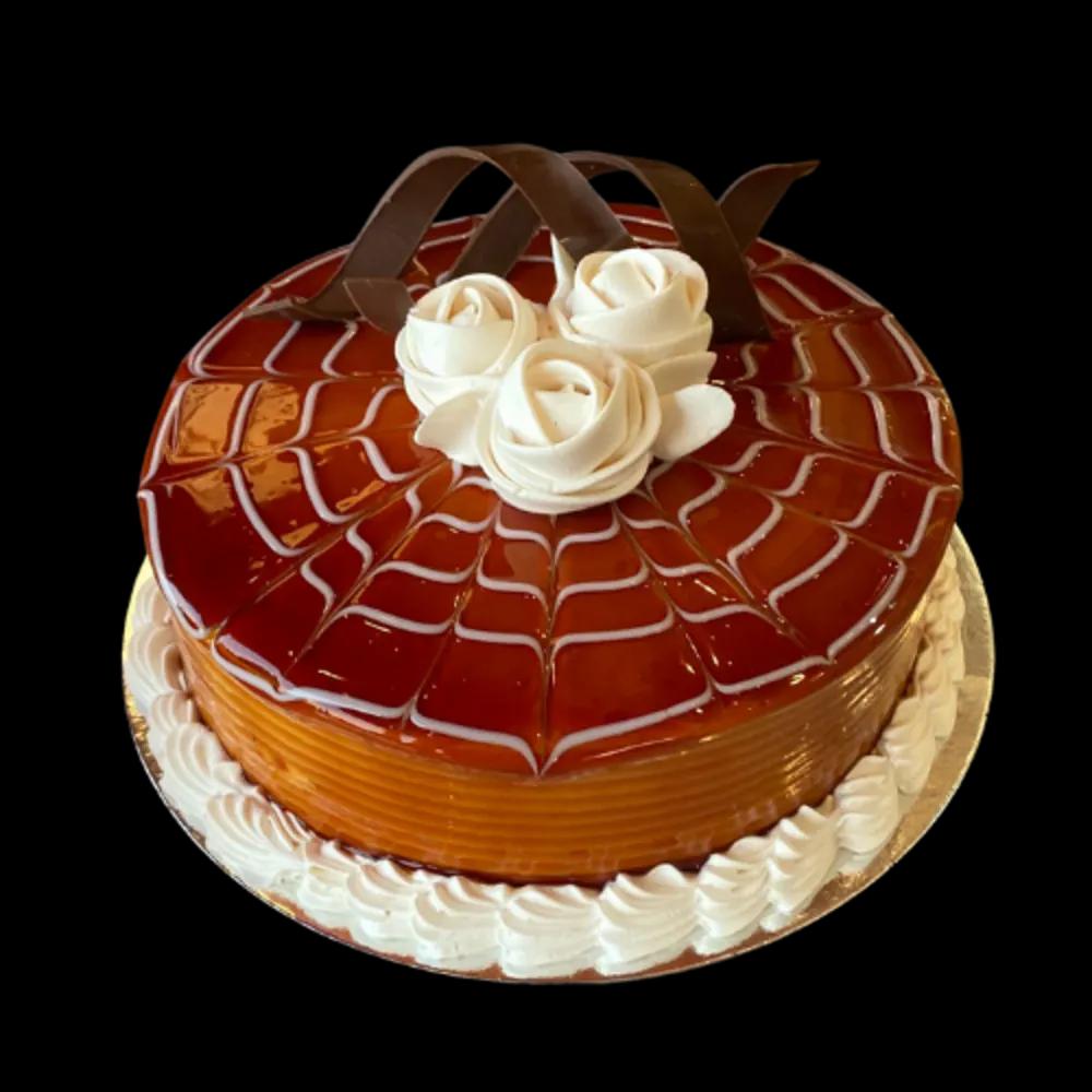 Chocolate and caramel cake decorated with creamundefined