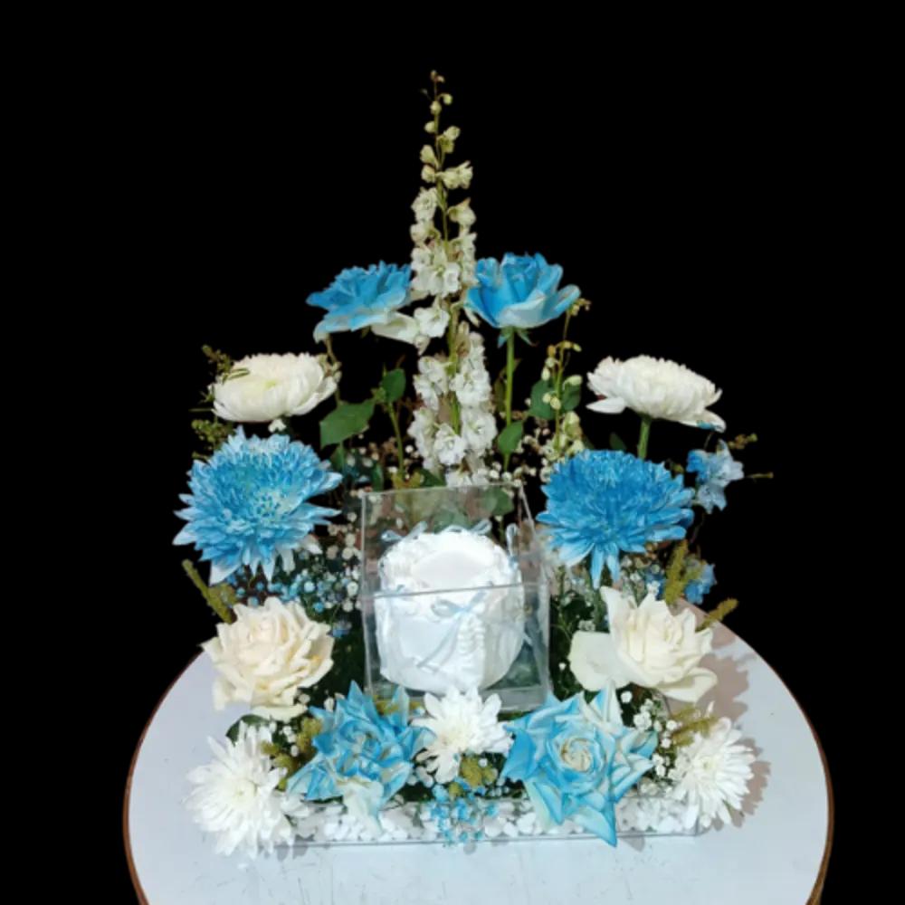 A tray of blue roses with white cake