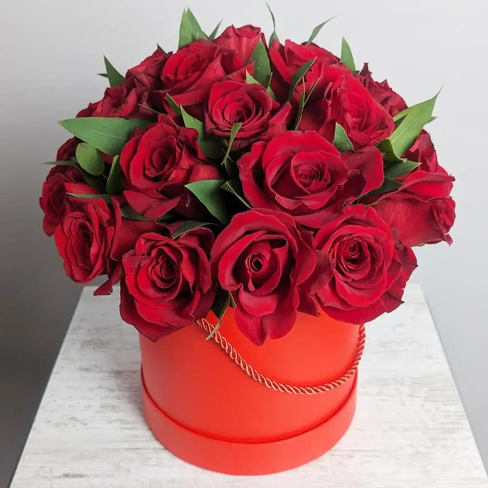 Maroon roses with eucalyptus in a red box