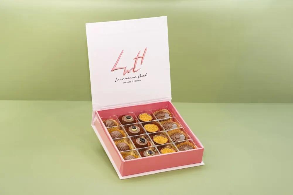 A luxurious chocolate box in an elegant pink color, featuring a sophisticated design that reflects luxury in every detail.