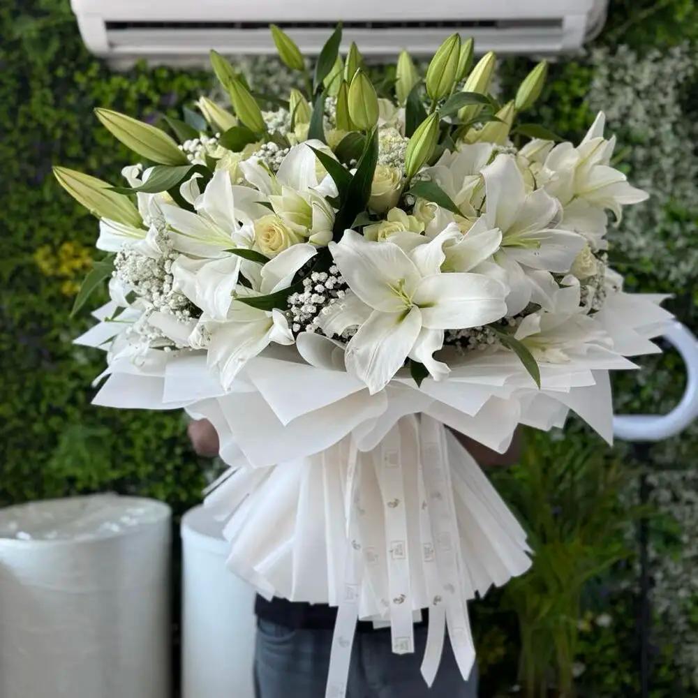 Hand bouquet of white lilies.